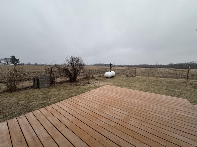 deck featuring a rural view and a lawn