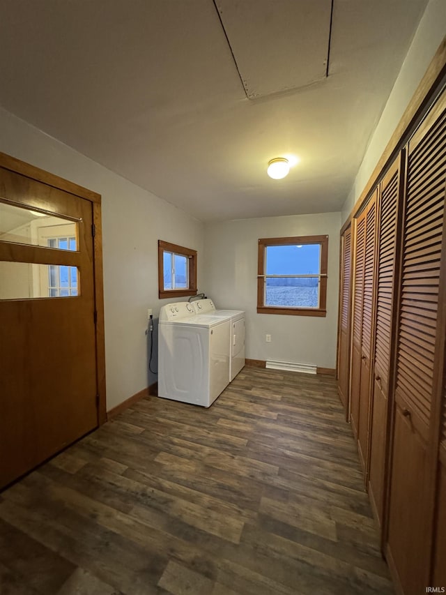 laundry area featuring washing machine and dryer and dark hardwood / wood-style flooring