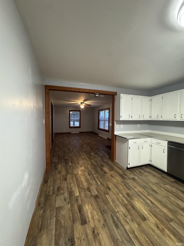 kitchen with white cabinetry, dishwashing machine, dark wood-type flooring, and ceiling fan