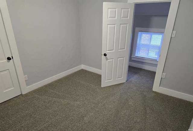 unfurnished bedroom featuring dark colored carpet