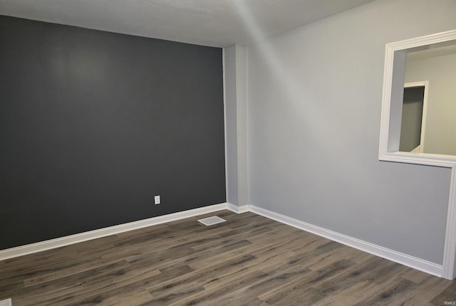 spare room with dark hardwood / wood-style floors