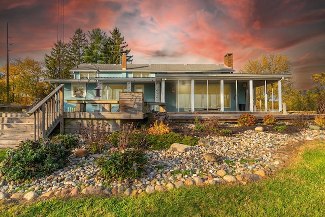 view of back house at dusk