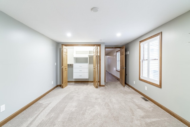 unfurnished bedroom with light colored carpet