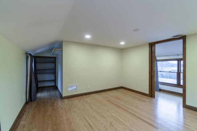 bonus room with lofted ceiling and light hardwood / wood-style flooring