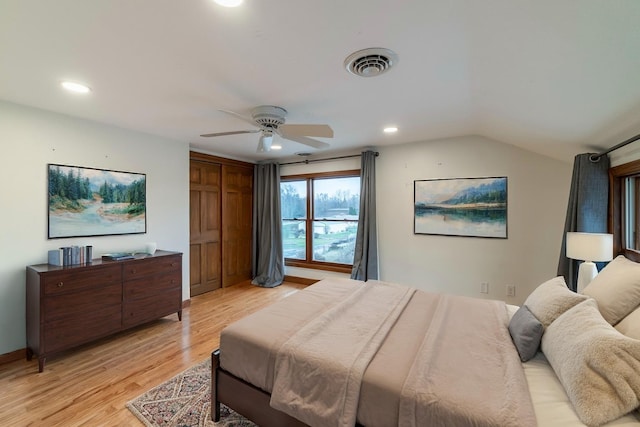 bedroom featuring ceiling fan, vaulted ceiling, and light hardwood / wood-style flooring