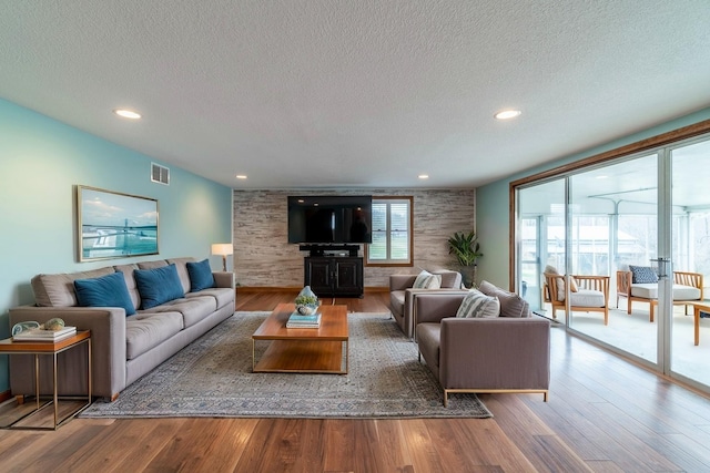 living room featuring hardwood / wood-style floors and a textured ceiling