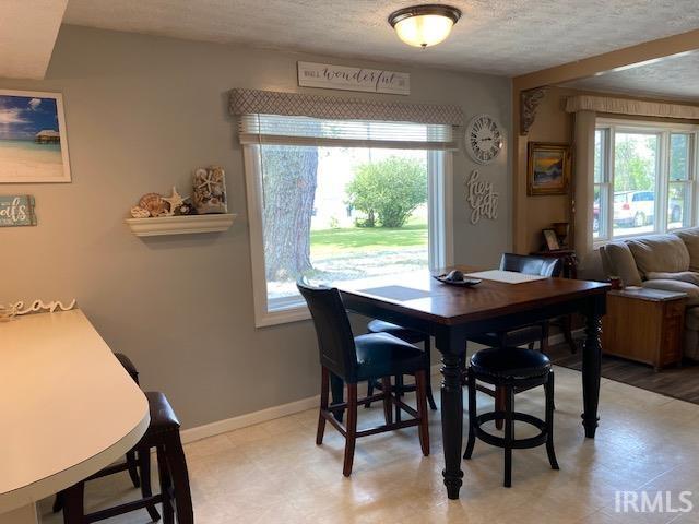 dining space featuring a textured ceiling