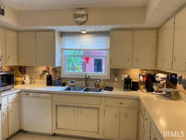 kitchen with a textured ceiling, dishwasher, backsplash, and sink