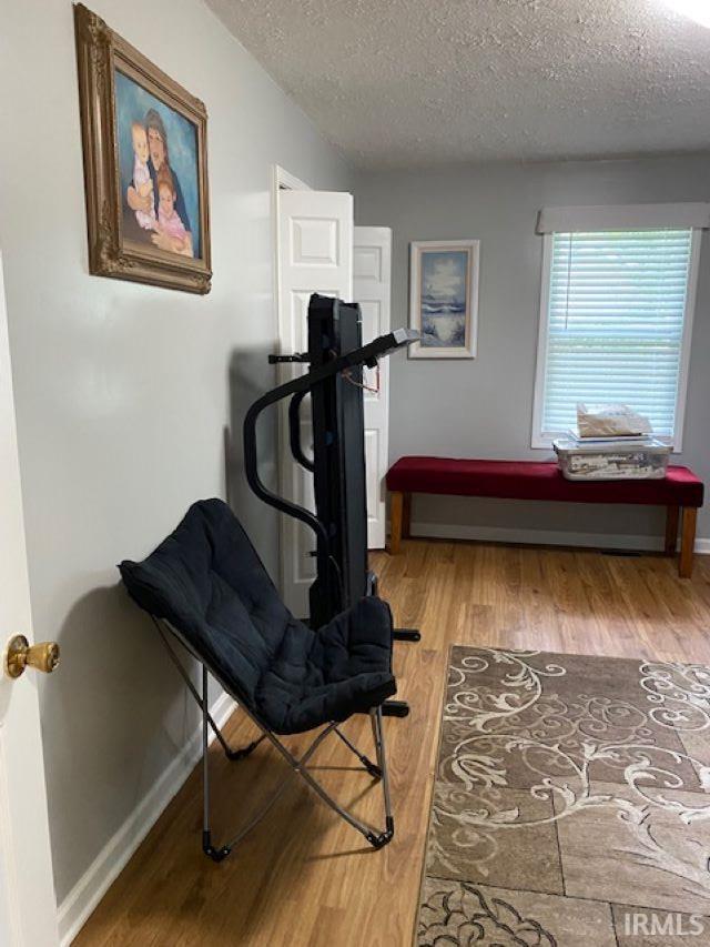 workout area with a textured ceiling and hardwood / wood-style flooring