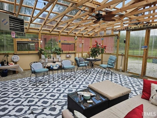 sunroom / solarium featuring ceiling fan and vaulted ceiling