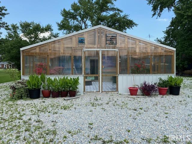 rear view of house featuring an outbuilding