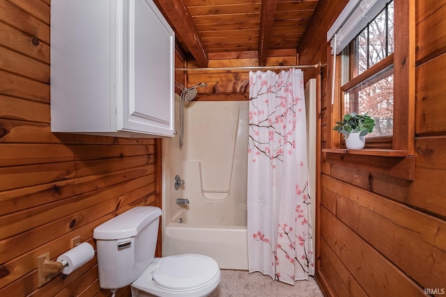 bathroom with wooden walls, shower / bathtub combination with curtain, wooden ceiling, beamed ceiling, and toilet