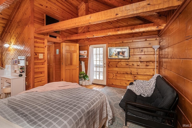 carpeted bedroom with beam ceiling, wooden walls, and wooden ceiling