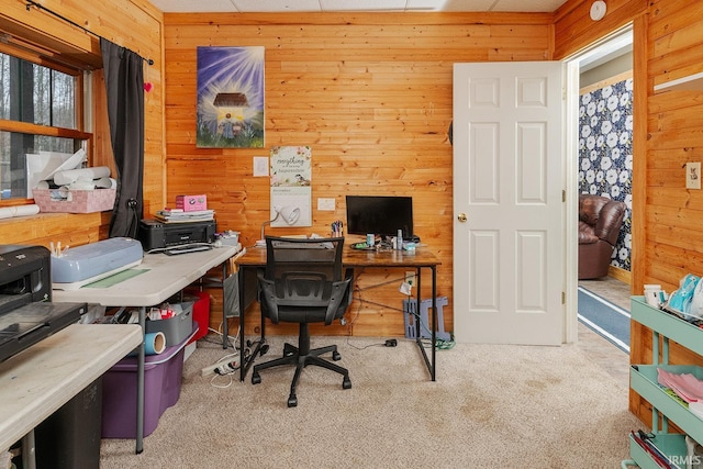 office space featuring wood walls and light colored carpet