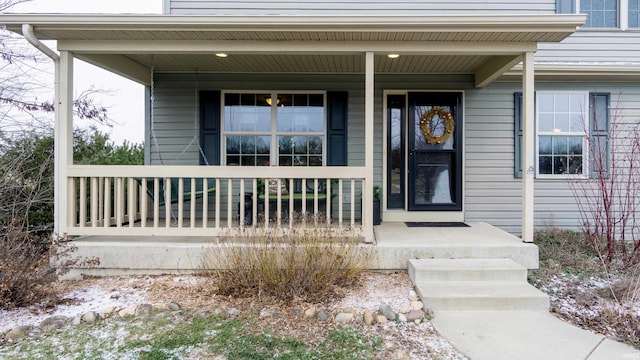 entrance to property featuring a porch