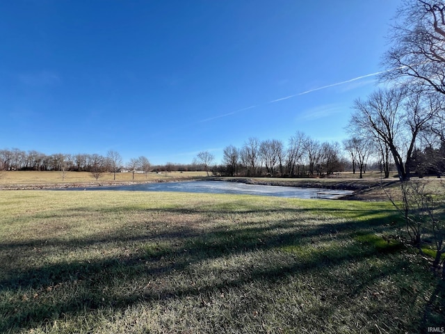 view of yard with a water view and a rural view