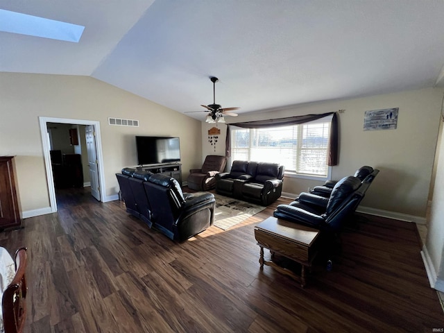 living room featuring ceiling fan, vaulted ceiling with skylight, and dark wood-type flooring