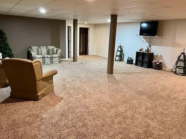 basement featuring carpet flooring and a drop ceiling