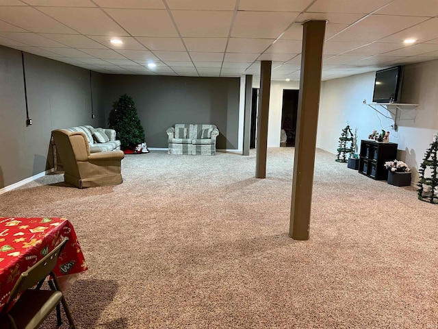 basement featuring a paneled ceiling and carpet floors