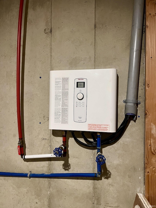 utility room featuring tankless water heater