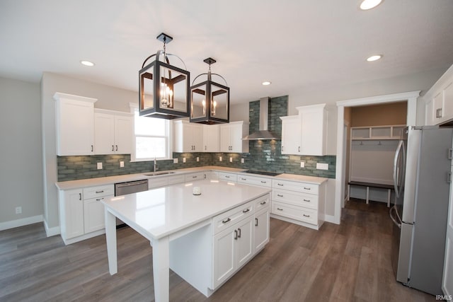 kitchen with white cabinets, stainless steel appliances, dark wood-type flooring, and wall chimney exhaust hood