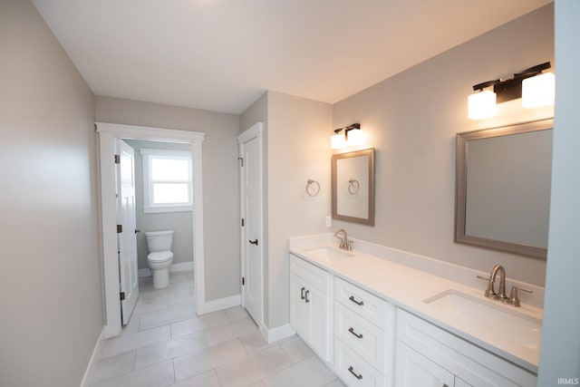 bathroom featuring tile patterned flooring, vanity, and toilet