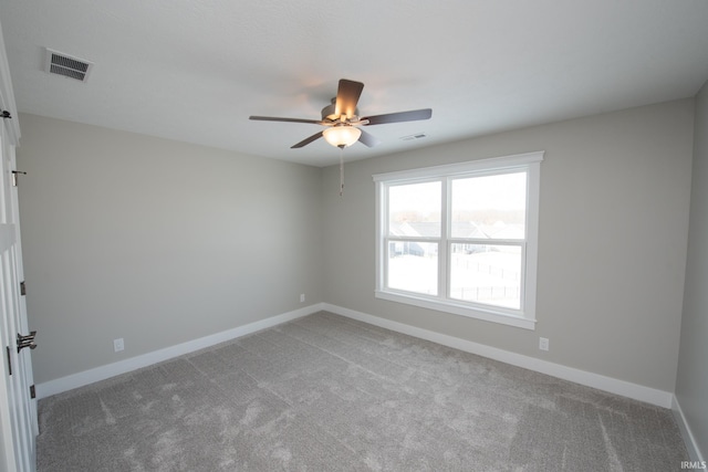 carpeted spare room with ceiling fan