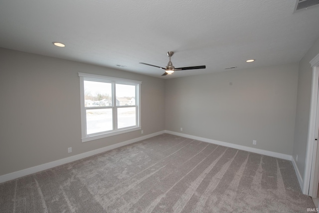 carpeted spare room featuring ceiling fan