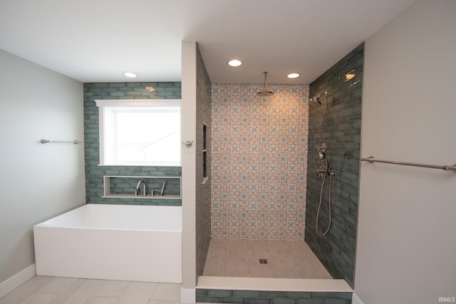 bathroom featuring tile patterned floors and independent shower and bath