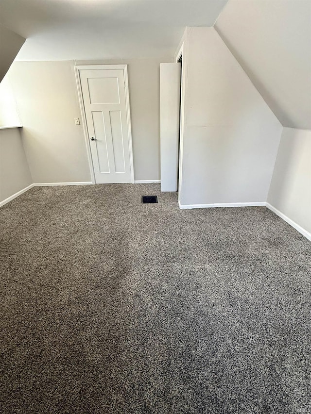 bonus room featuring carpet and vaulted ceiling