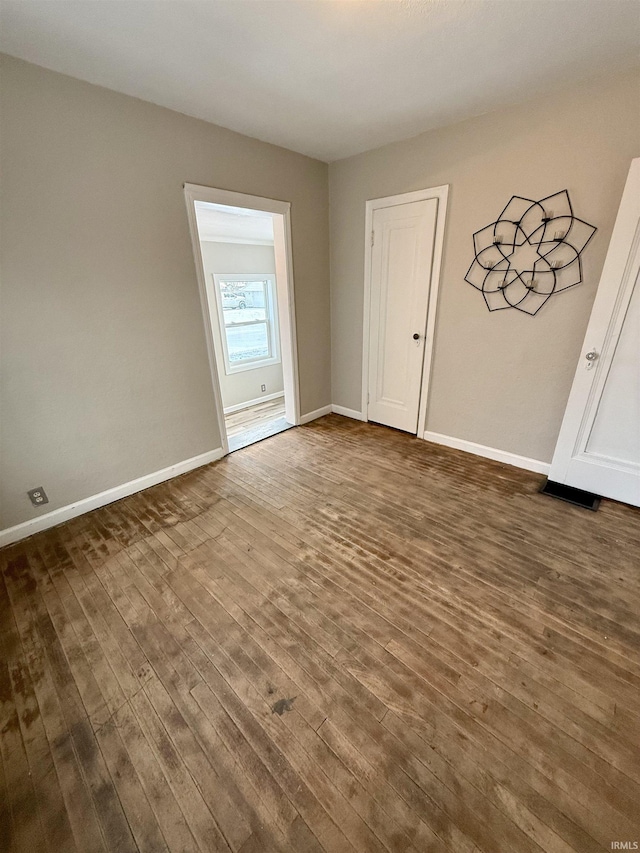 spare room with dark hardwood / wood-style flooring