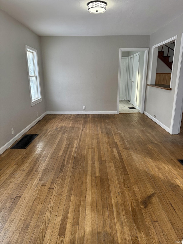 empty room with hardwood / wood-style flooring