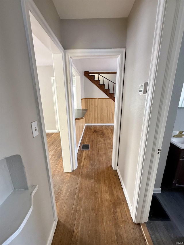 corridor with sink and hardwood / wood-style flooring