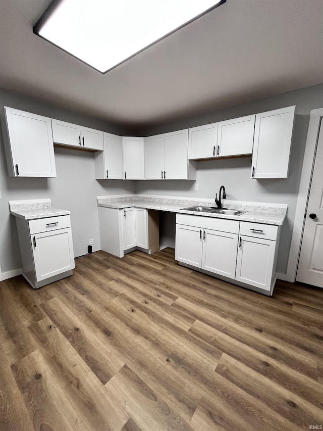 kitchen featuring white cabinetry and sink