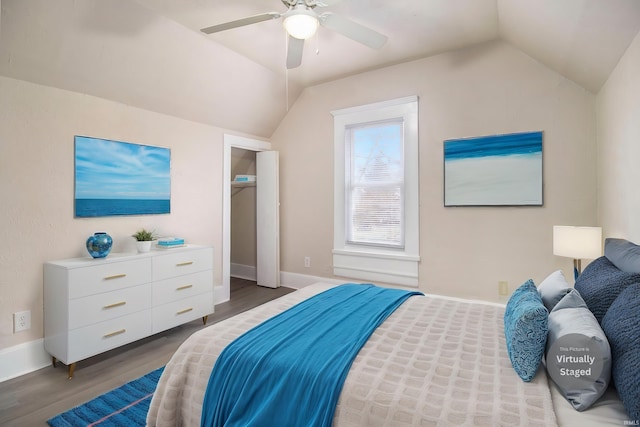 bedroom featuring dark hardwood / wood-style floors, ceiling fan, and vaulted ceiling