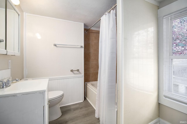 full bathroom with shower / tub combo, vanity, crown molding, hardwood / wood-style flooring, and toilet