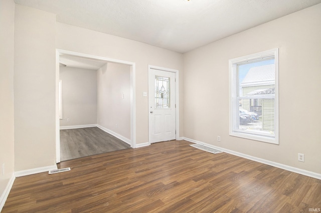 entrance foyer with dark hardwood / wood-style floors