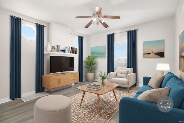 living room with ceiling fan, hardwood / wood-style floors, and a healthy amount of sunlight