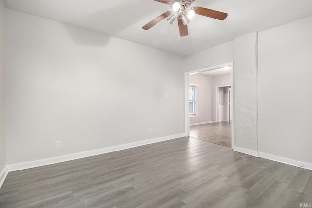 unfurnished room featuring ceiling fan and dark hardwood / wood-style flooring