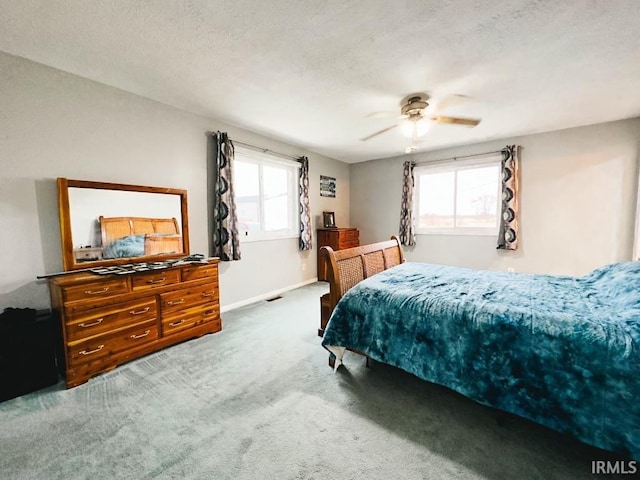 bedroom featuring multiple windows, ceiling fan, and carpet