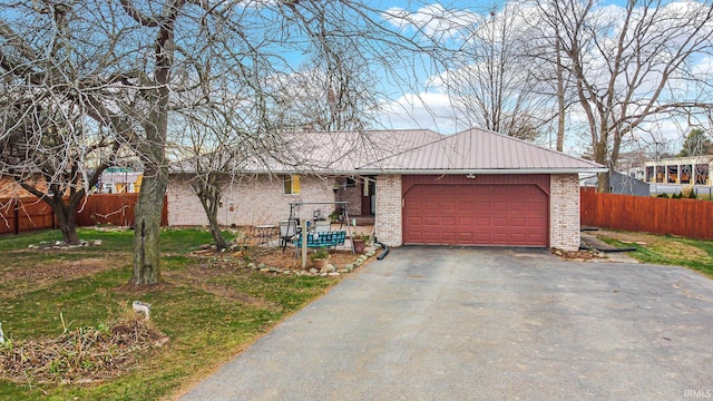 ranch-style house with a front yard and a garage