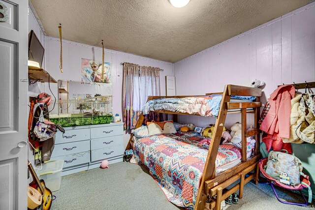 carpeted bedroom featuring a textured ceiling