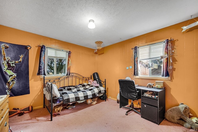 bedroom featuring carpet floors and a textured ceiling