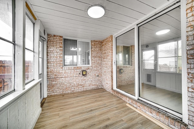 unfurnished sunroom featuring wood ceiling