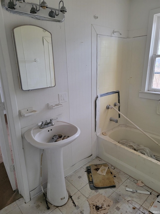 bathroom featuring tile patterned flooring and a tub to relax in