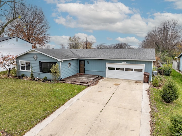 ranch-style house with a garage and a front lawn