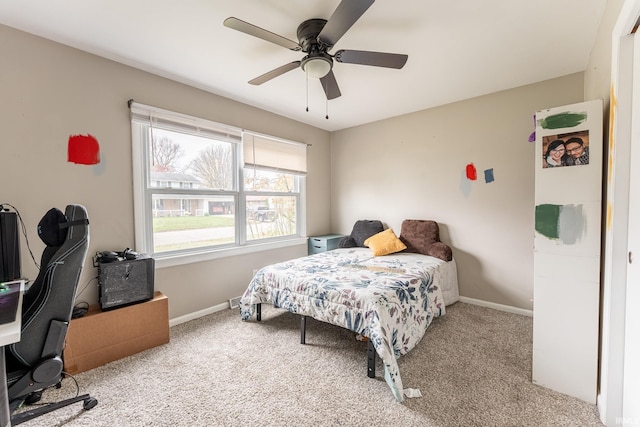 bedroom with ceiling fan and light carpet