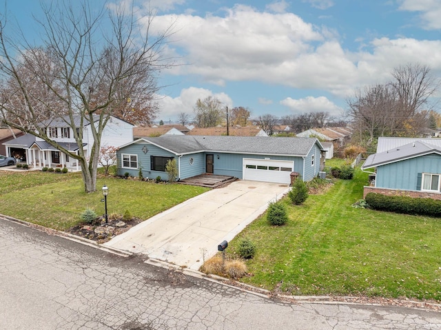 ranch-style house featuring a front yard and a garage