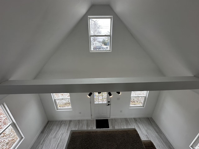 bonus room featuring vaulted ceiling and light hardwood / wood-style flooring