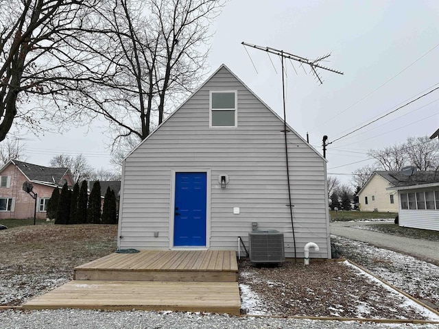 back of property featuring cooling unit and a wooden deck